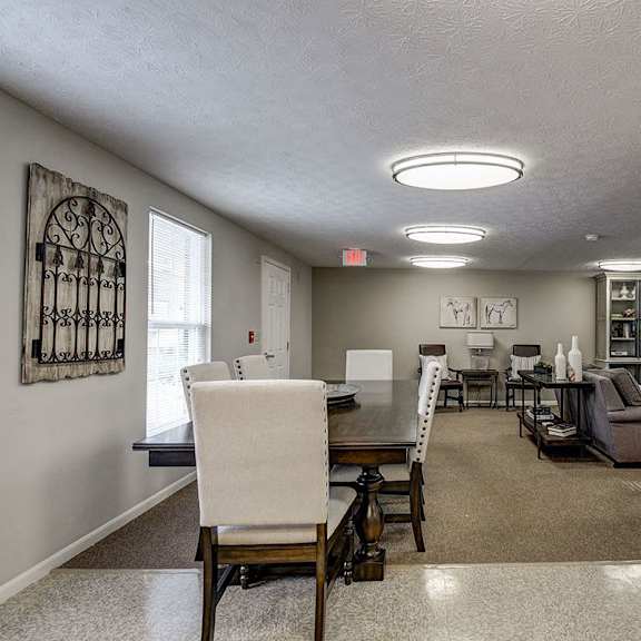a dining room with a table and chairs.