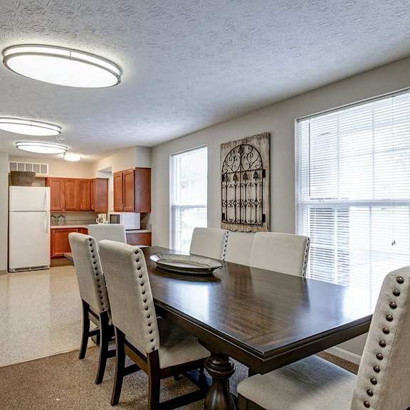 a dining room with a wooden table and chairs.