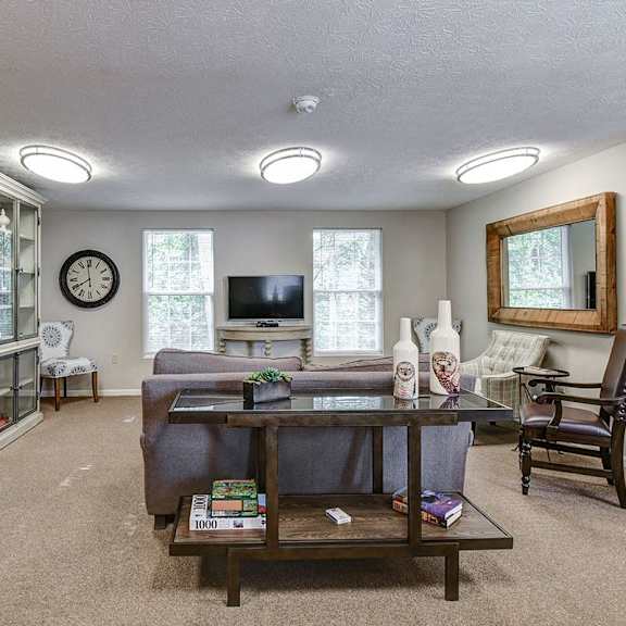 a living room with a couch, chair, and a coffee table.