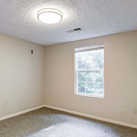 a room with a window and a ceiling light.