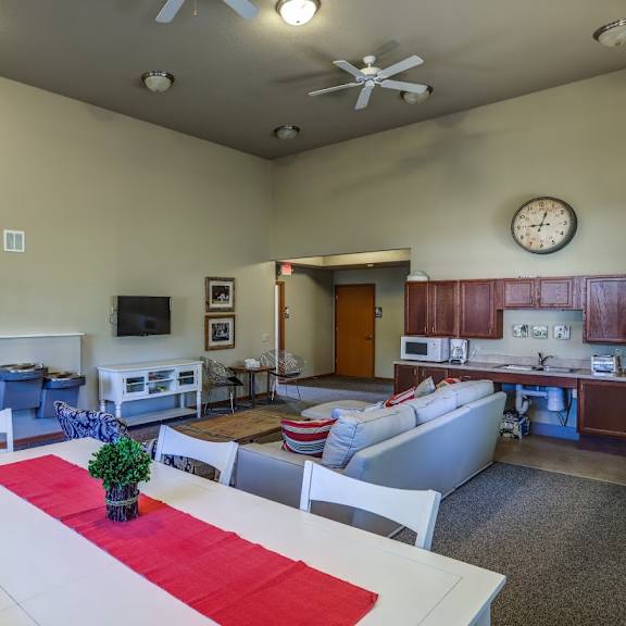 an open concept living room and kitchen with a dining table and chairs