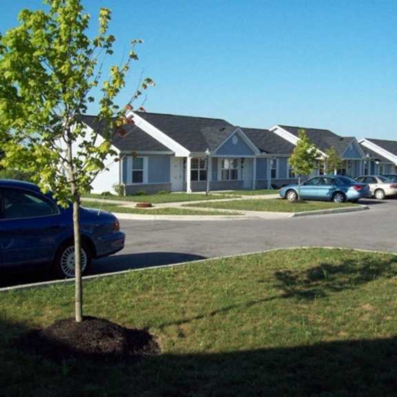 a street with cars parked in front of houses
