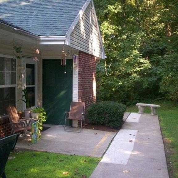 a patio in front of a house with a bench