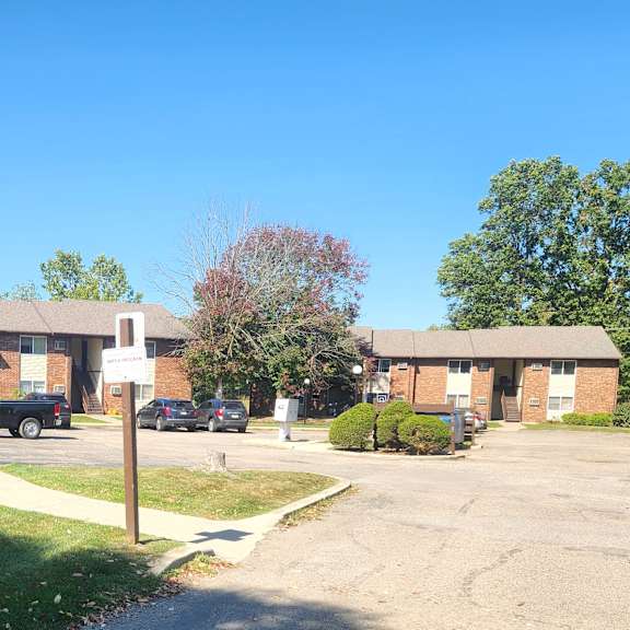 an apartment building with cars parked in front of it