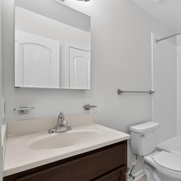 a white toilet sits next to a sink in a bathroom.