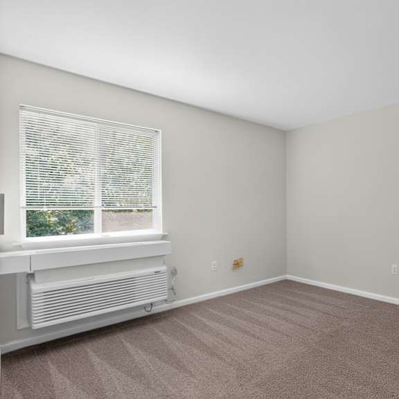 a room with a window and a radiator on the floor.