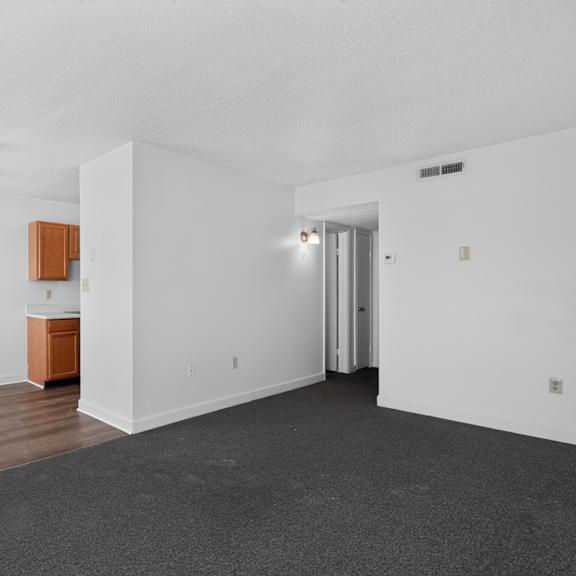 a room with a ceiling fan and a cabinet.