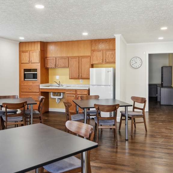 a kitchen with wooden cabinets and a white fridge.