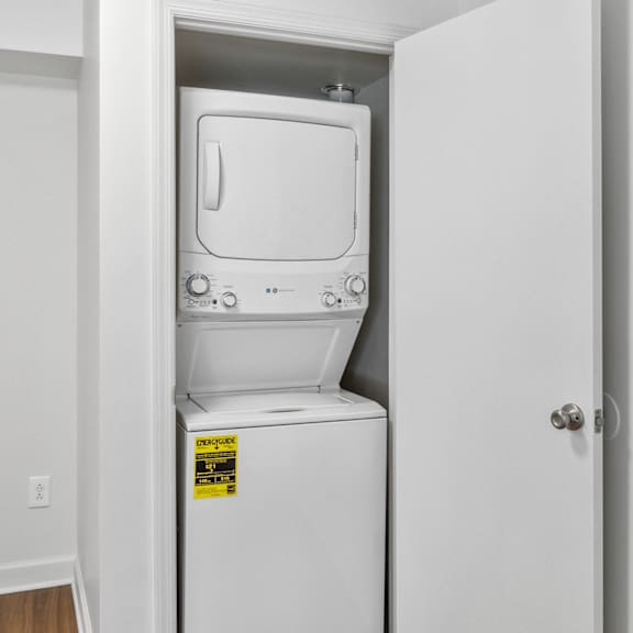 a white fridge in a white room.