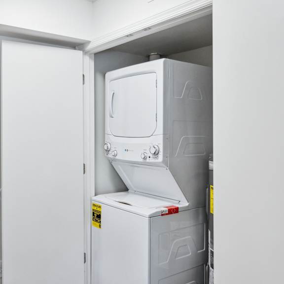a white refrigerator is installed in a white room.