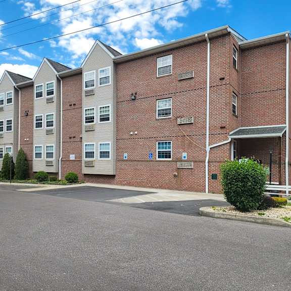 a large brick apartment building with a street in front of it