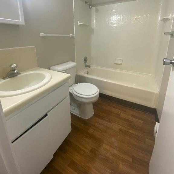 a bathroom with a sink toilet and a bath tub