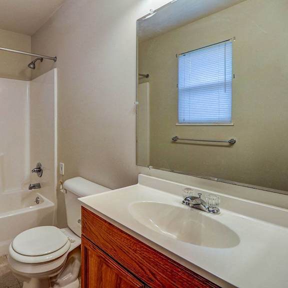 a bathroom with a sink toilet and a bath tub