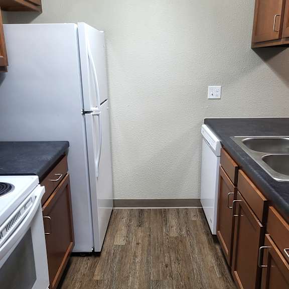 kitchen white fridge and stock with cabinets