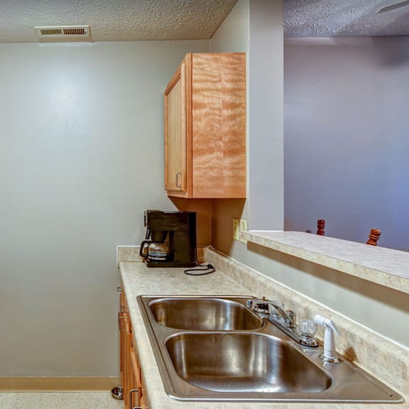 an empty kitchen with a stove sink and refrigerator