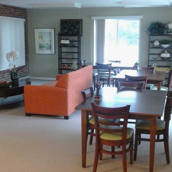 a living room with a brick wall and a television.