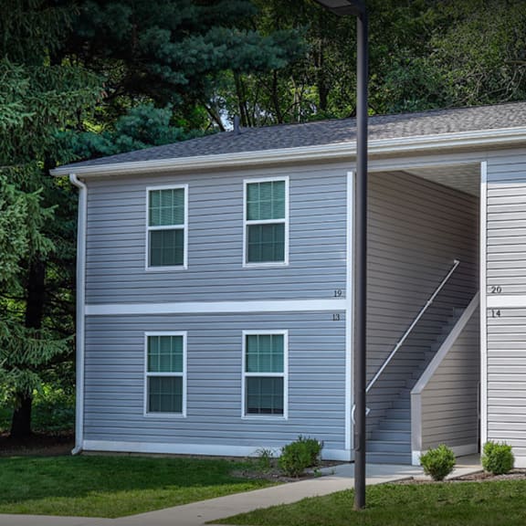 apartment building with sidewalk and grass