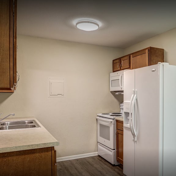 a kitchen with a refrigerator and a sink