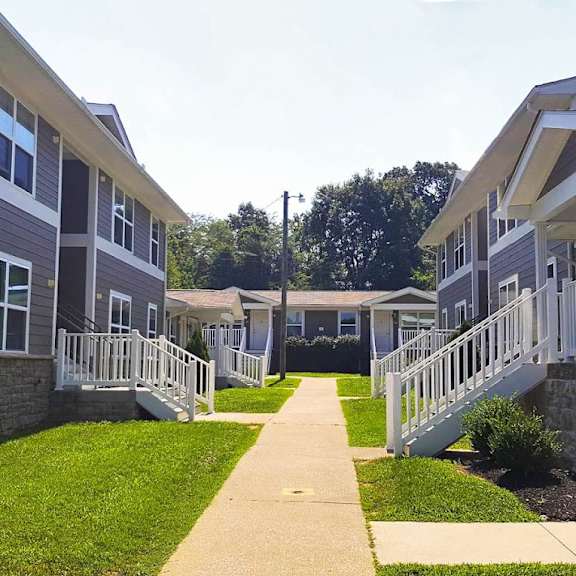 a row of houses with stairs and grass