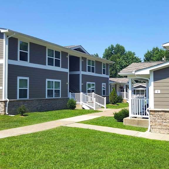 a row of houses in a neighborhood with green grass