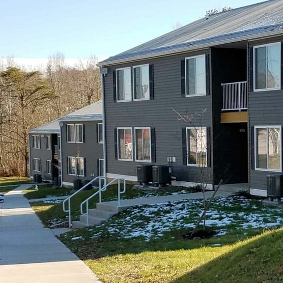 a row of houses with a snow covered yard