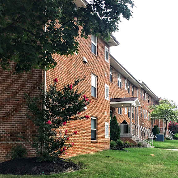 a large brick building with a tree in front of it