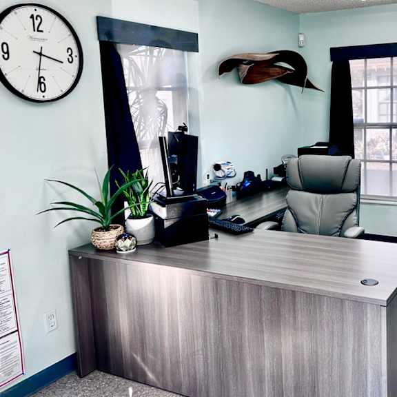 a reception desk with a clock on the wall above it.