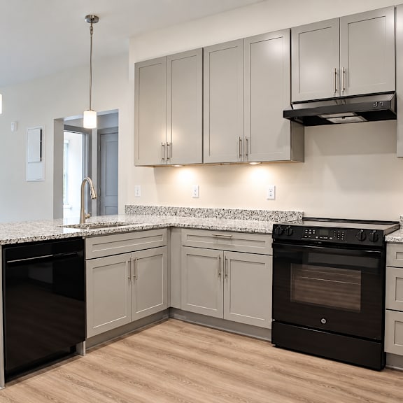 a kitchen with a black oven and a white counter.