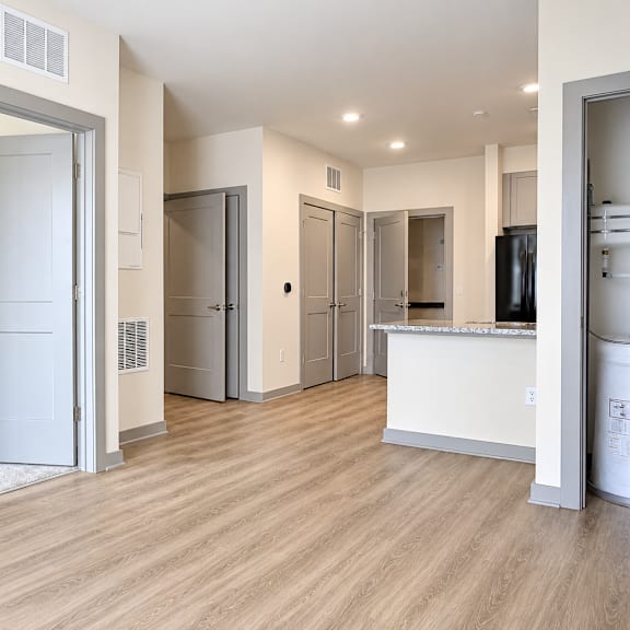 a room with a white wall and a wooden floor.