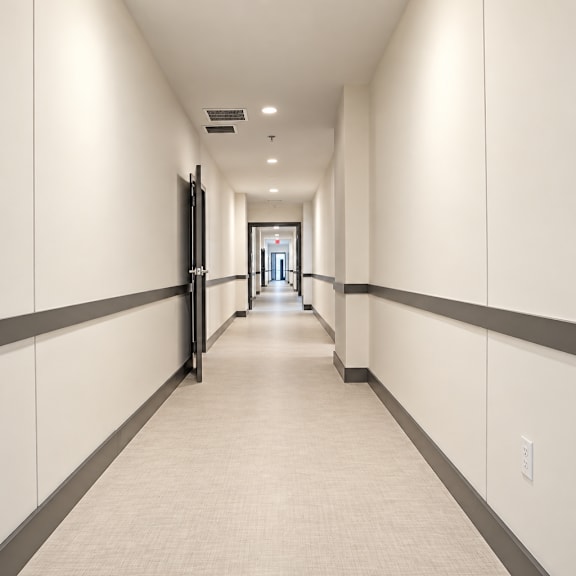 a long hallway with a door at the end.