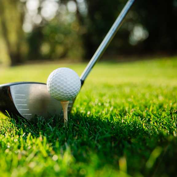 a golf ball is on a tee ready to be hit.