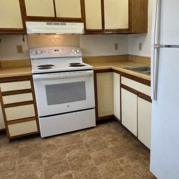 a kitchen with a stove and a refrigerator