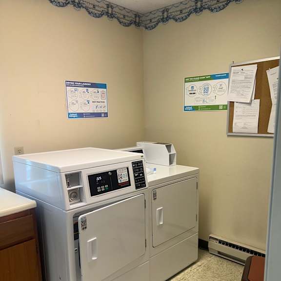 a white washing machine and dryer in a small room.