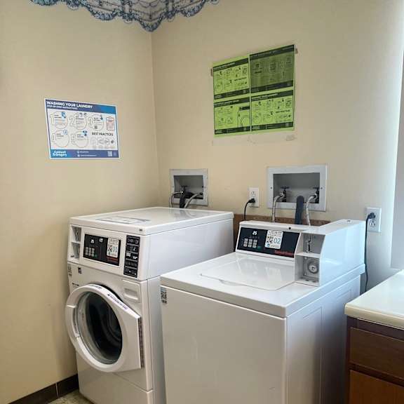 a wall with a sign and a picture of a washing machine.