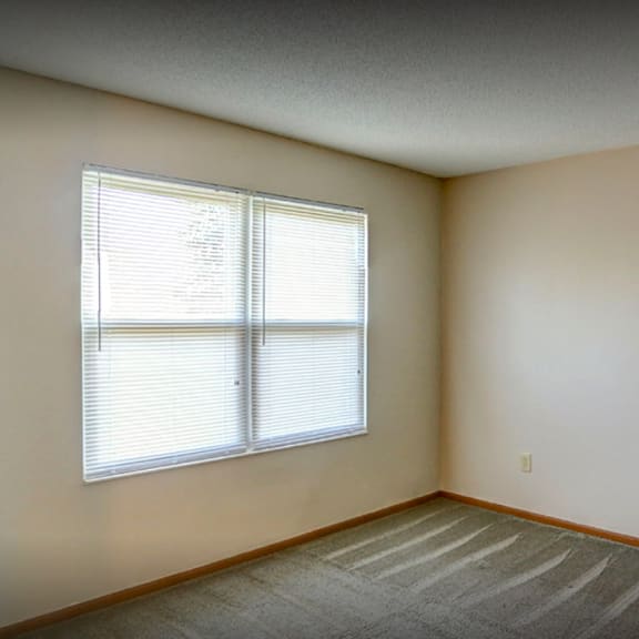 the living room of an empty house with a window