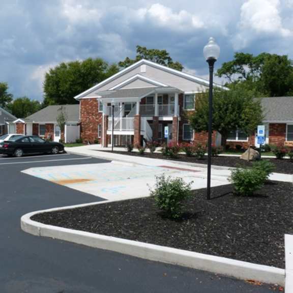 an empty parking lot in front of a house