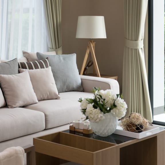 a living room with a white couch and a coffee table