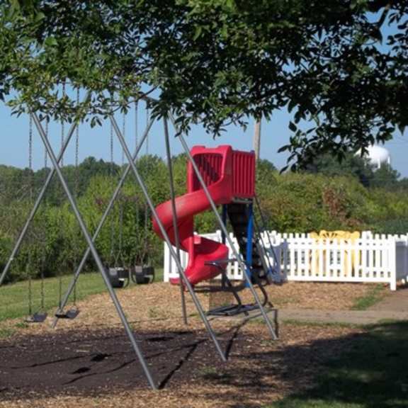 a swing on a swing set in a park