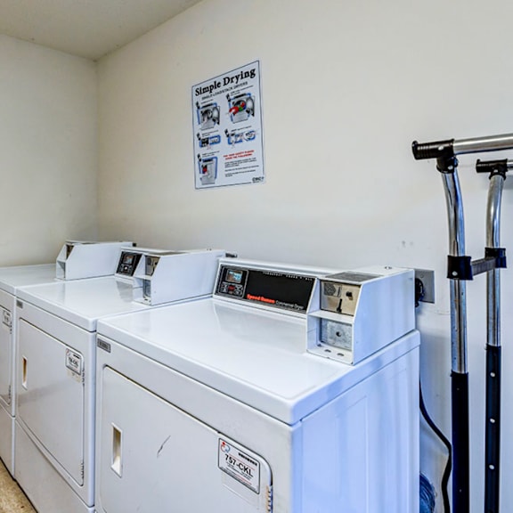 a laundry room with two washes and two washing machines