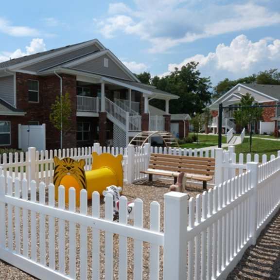 a white picket fence in front of a house