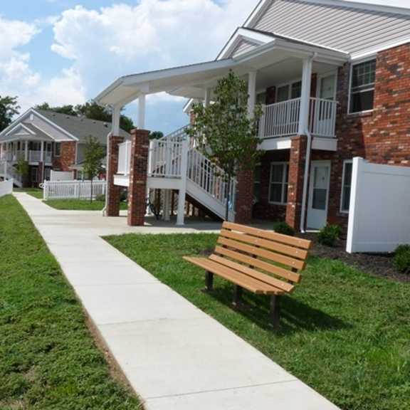 a wooden bench in front of a building