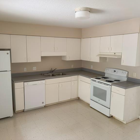 a kitchen with white appliances and cabinets.