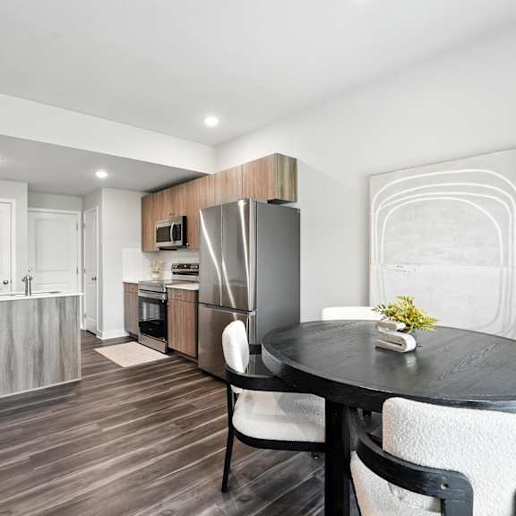 Thumbnail 10 of 23 A modern kitchen with a dining table set for two.