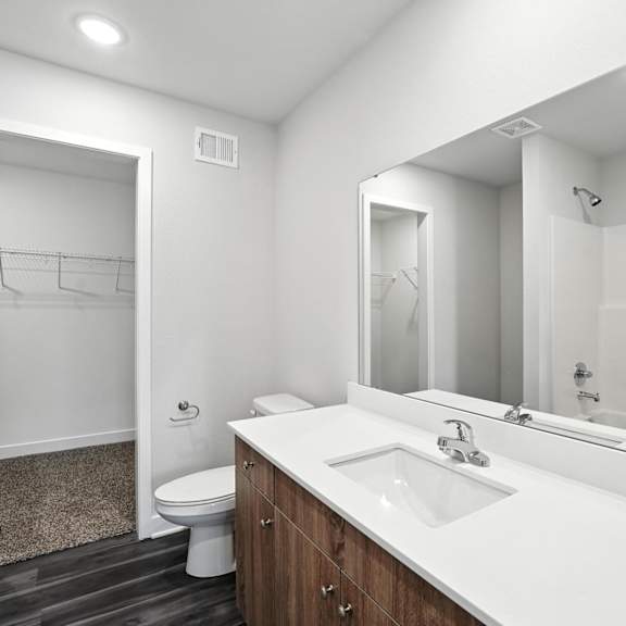Thumbnail 14 of 23 A bathroom with a white sink and a mirror.