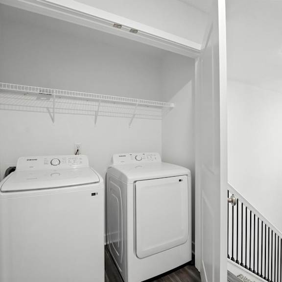 Thumbnail 23 of 23 A white laundry room with a washer and dryer.