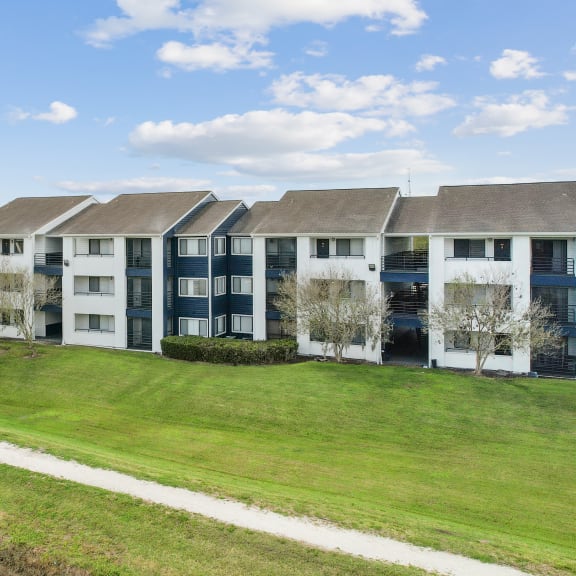 an image of an apartment building next to a body of water