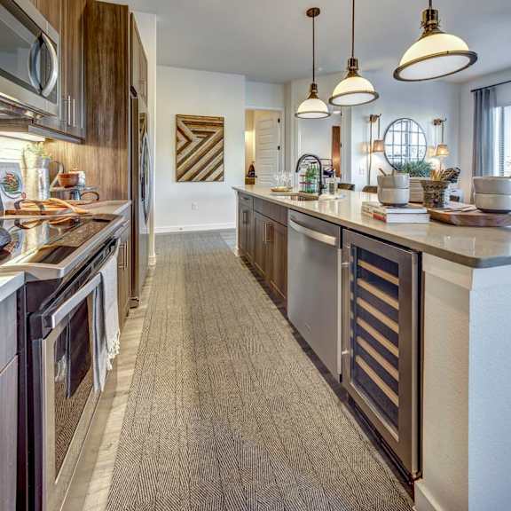a modern kitchen with a long counter and a large island.
