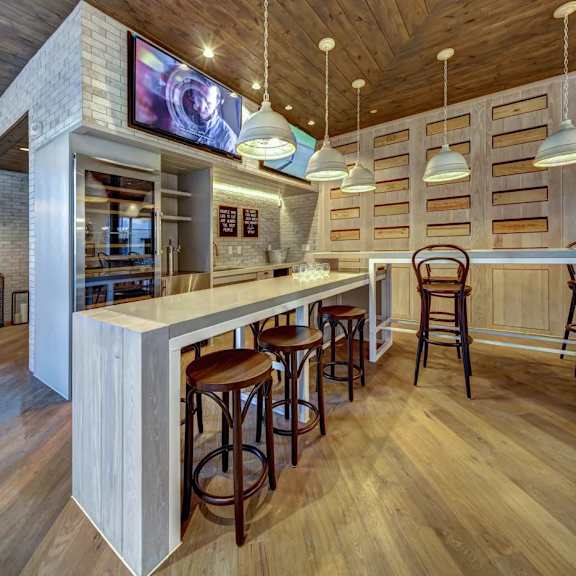 a bar with wooden floors and a white counter.