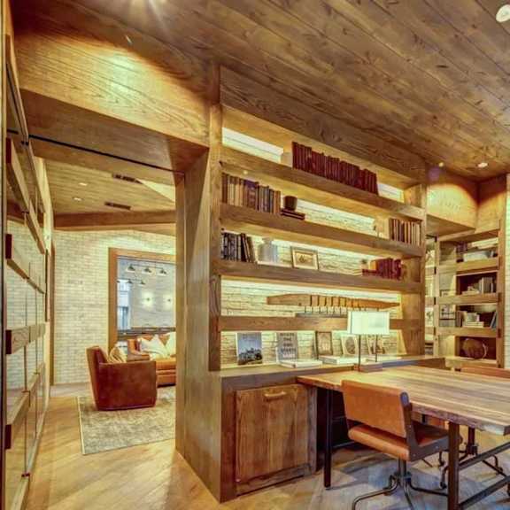 a room with a wooden ceiling and a long table with chairs.