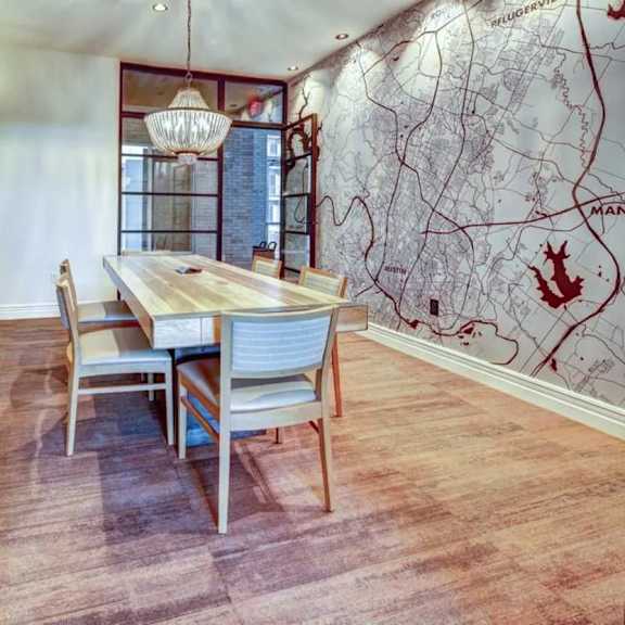 a dining room with a wooden table and chairs.